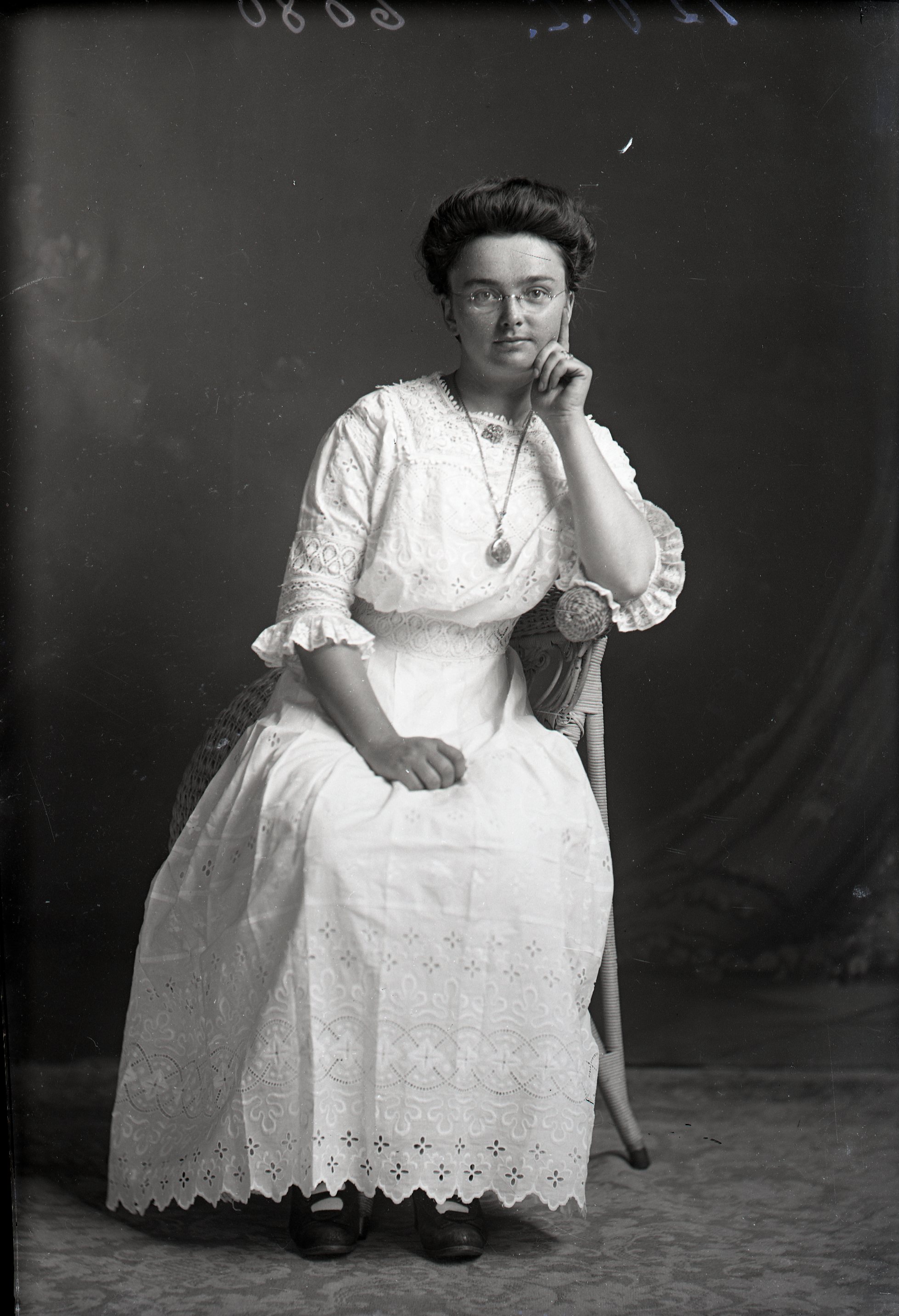 Woman with glasses, seated