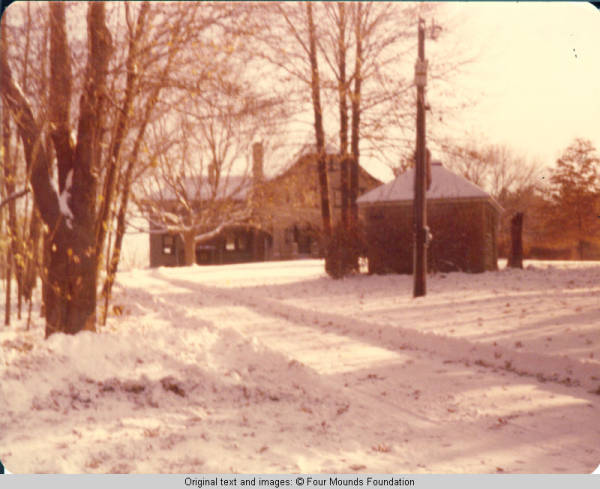 View of service drive up to Grey house in Winter