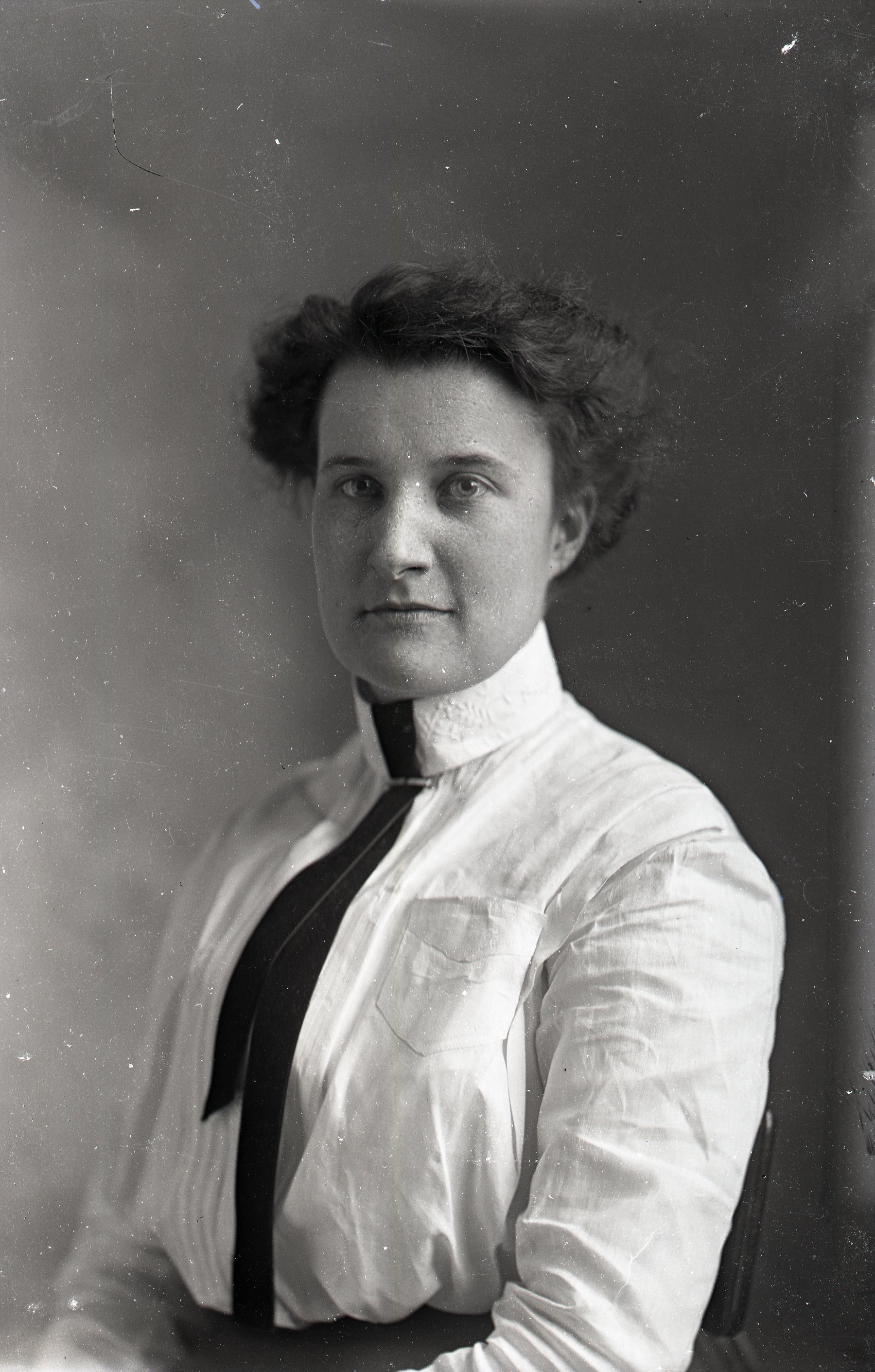 Woman standing with tie
