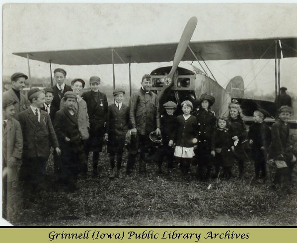 Billy Robinson with Canadian school children and biplane