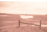Fenced farmland with Water in the Field