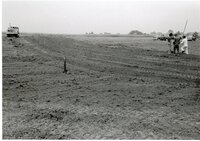 Bulldozed field with water drainage pipes