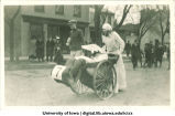 Wheelchair in parade, The University of Iowa, 1920s