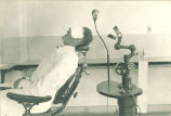 Dental patient in chair, The University of Iowa, 1920s