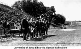 Governor's Day VIPs standing in front of awards table and crowd, Iowa Field, The University of Iowa, May 22, 1926