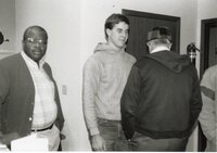 Terry Cosby and John Fruehling stand in a hallway with a man whose back faces the camera.