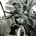 Homecoming attendant and two men with the Phi Delta Theta Victoryland homecoming lawn display, 1961