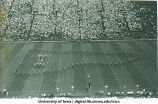 Marching band performing at football game, The University of Iowa, 1940s
