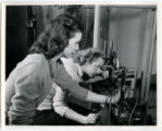 One cadette is using an optical telescope system in the Aeronautical Laboratory, 1943