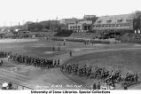 Cadets with rifles and sabers during Governor's Day ceremony on Iowa Field, The University of Iowa, May 2, 1918