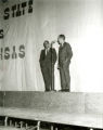 President Parks at the microphone on stage with another man on the night before Homecoming, 1969