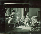 Woman at piano and children with musical instruments, The University of Iowa, February 22, 1938