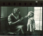 Woman holds a small girl's chin, The University of Iowa, May 10, 1941