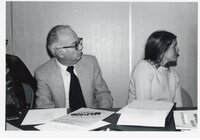Three unidentified people at unidentified meetings