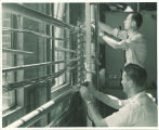 Engineering students working with metal tubing in engineering laboratory, The University of Iowa, 1939