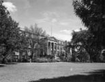 Curtiss Hall west elevation with budding trees, 1954