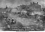 Horse-drawn wagons outside Clinton St. businesses, Iowa City, Iowa, 1854