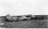 Horse and buggy next to large boulders, Iowa, late 1890s or early 1900s