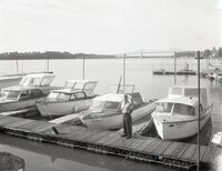 Man stands on dock by boats