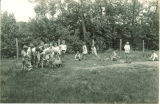 Students working in garden and feeding lamb during school open house, The University of Iowa, June 1, 1930