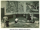 Students painting modern art wall hanging, The University of Iowa, March 4, 1940