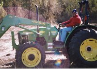 2002  Terrance Rudolph, Des Moines County Soil and Water Conservation District Conservationist, drives a  John Deere tractor.