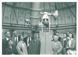 People gazing at telescope in observatory, The University of Iowa, 1950s