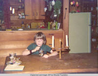 John, Jr. sitting at table