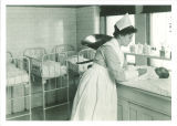 Nurse preparing to weigh baby in Children's Hospital, The University of Iowa, 1926