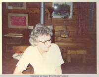 Eleanor sitting at table, looking left 