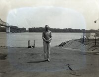 Man stands at edge of river