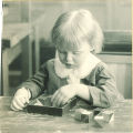 Toddler playing with a puzzle, The University of Iowa, 1920s