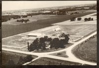 Aerial view of farm surrounded by trees