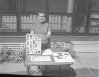 Unidentified woman shows rock samples in tray