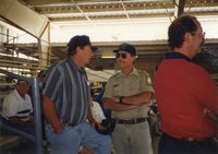 1997 Dwight Stucker, award winner, Jeff Bergman, Commissioner and Bruce Trautman,  Area Conservationist from the Des Moines County Soil and Water Conservation District Office stand talking at the Ag Expo