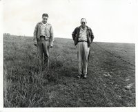 Unidentified men walking in a field