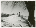 Snow drift against fence