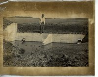Man standing on a water control structure
