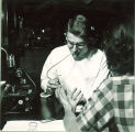 Dental student drawing blood from patient with pipette, The University of Iowa, November 1952