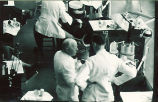 Faculty member teaching a dental student in a clinic, The University of Iowa, 1950s