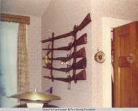 View of gun rack with rifles and powder horn