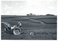 Richard Wall on tractor talking to Floyd Parks, 1968