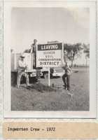 Bob Ingwersen and his Son Stand by the 'Entering' and 'Leaving Dickinson Soil &amp; Water Conservation District' Sign.