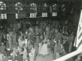 Milling crowd in State gym after football game, 1952
