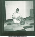 Man dressed in a traditional costume playing drums, 1960s