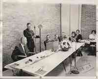 Group seated at Meeting with Man in Wheelchair