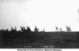 Cadets running through field with rifles, The University of Iowa, 1918