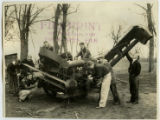 Men working on farm equipment, 1931