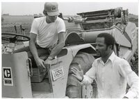 1979  Soil conservation technician talks to man on Caterpillar 613 earthmoving machine