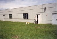 1999 Student brings a tree in a bucket out of West Burlington High School to be planted with other trees sitting in buckets